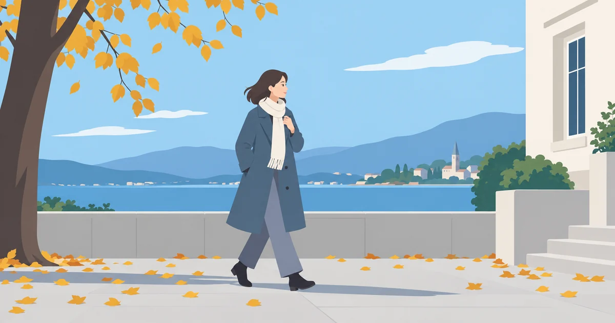 秋の屋外でコートを着て、肌寒さに合わせて服装を調整する様子